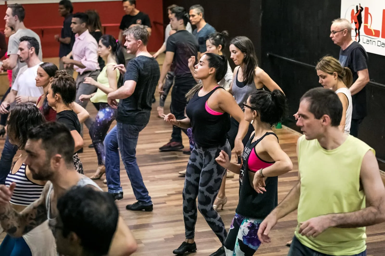 A Sydney salsa class in progress, couples working through a pattern